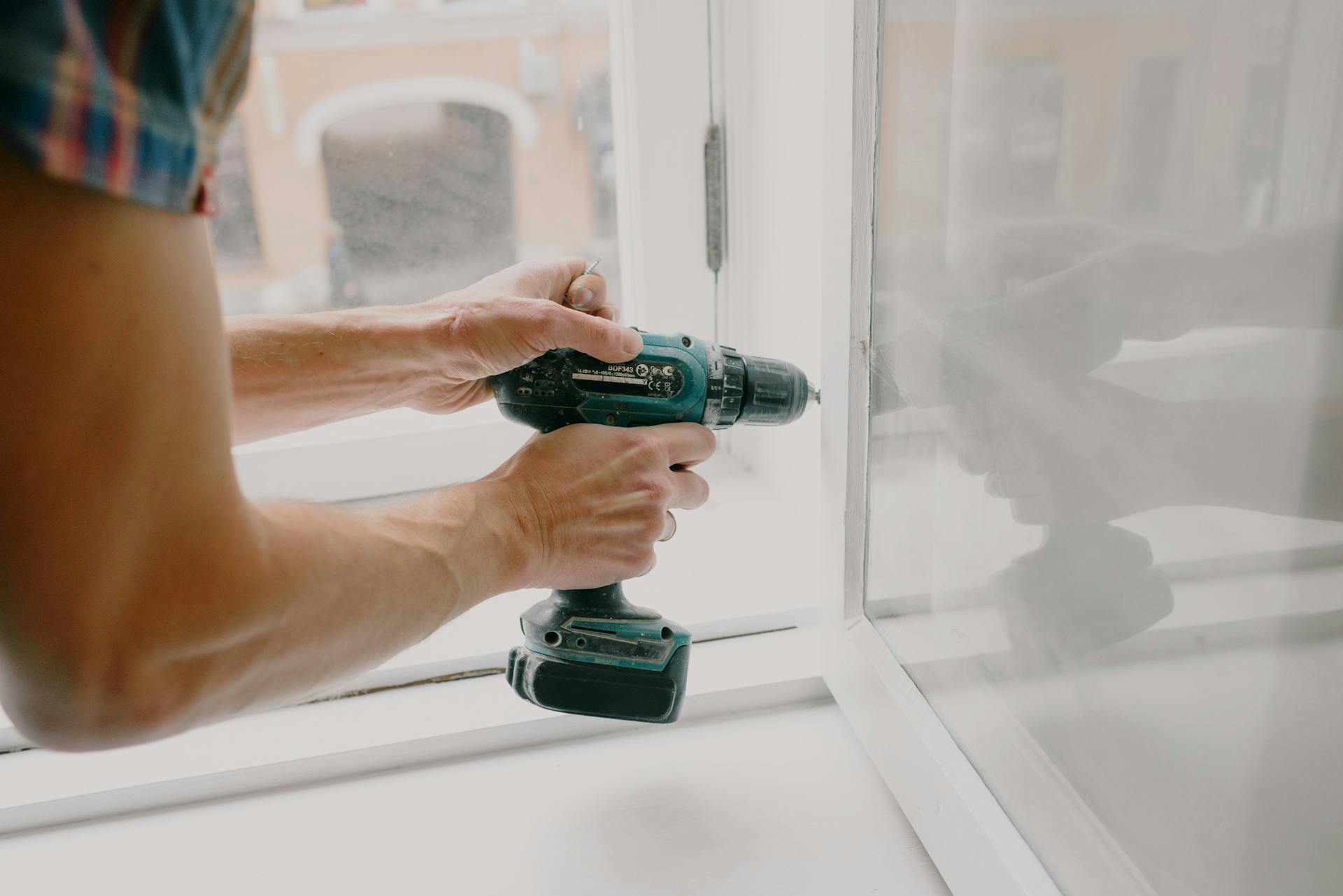 Nahaufnahme eines Mannes, der ein Fenster repariert | Quelle: Pexels