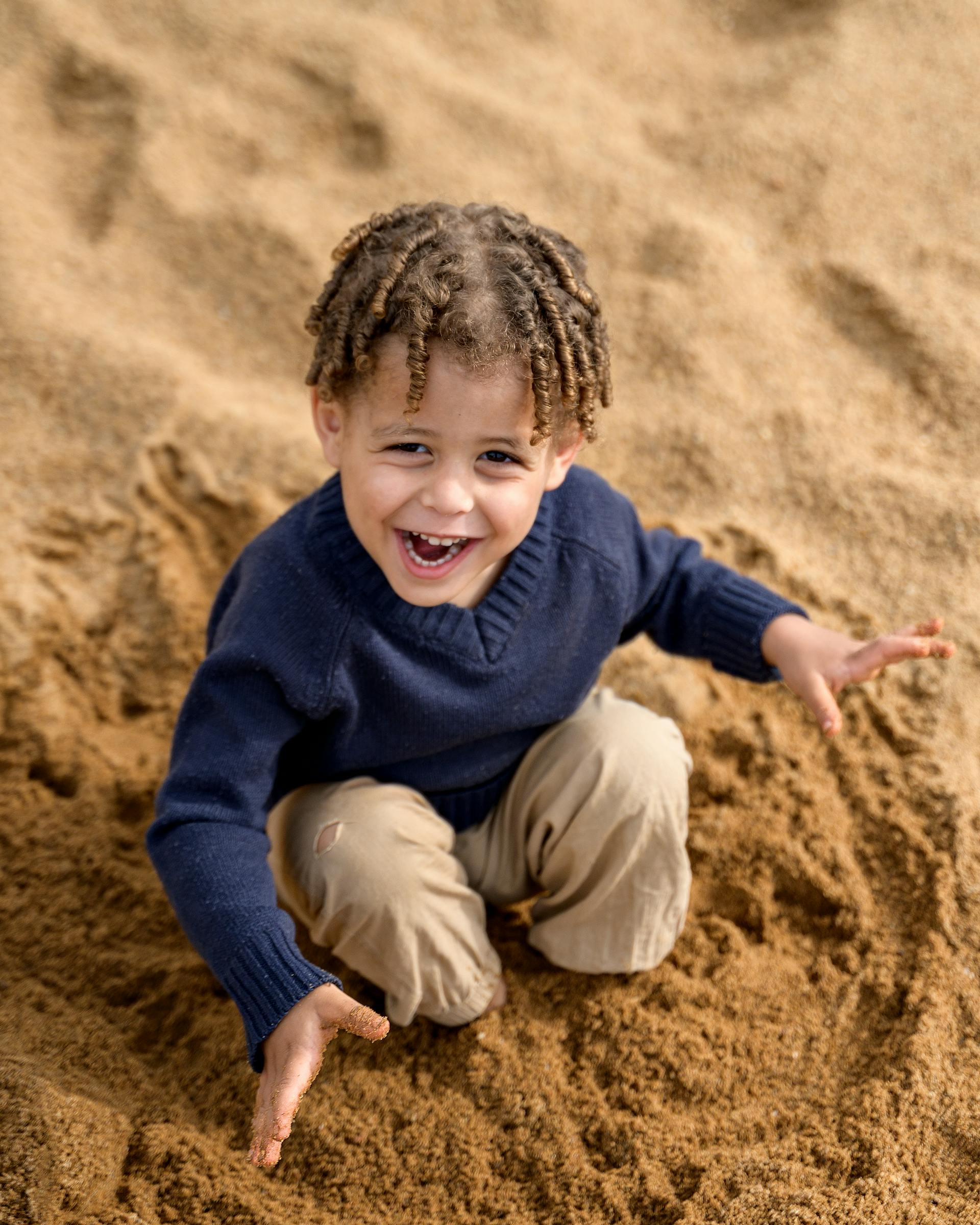 Ein kleiner Junge spielt im Sand | Quelle: Pexels