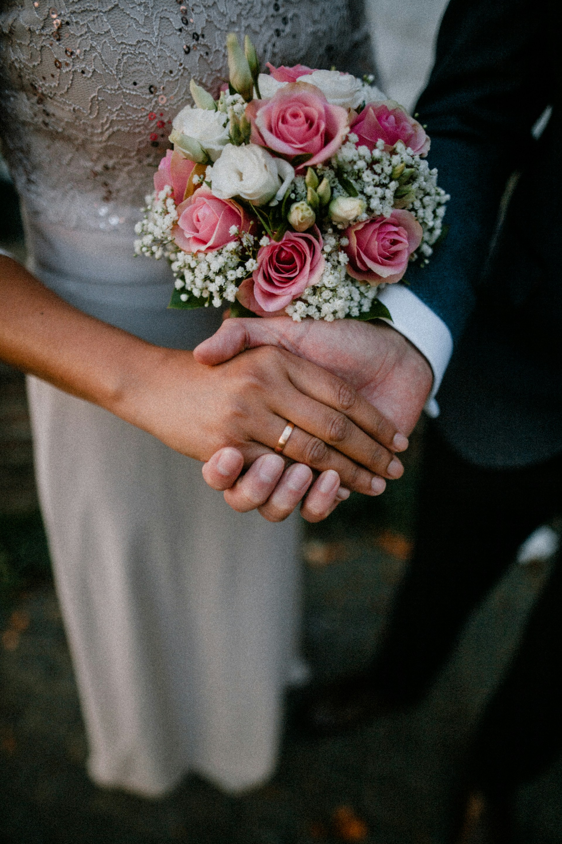 Ein Bräutigam hält die Hand seiner Braut | Quelle: Unsplash