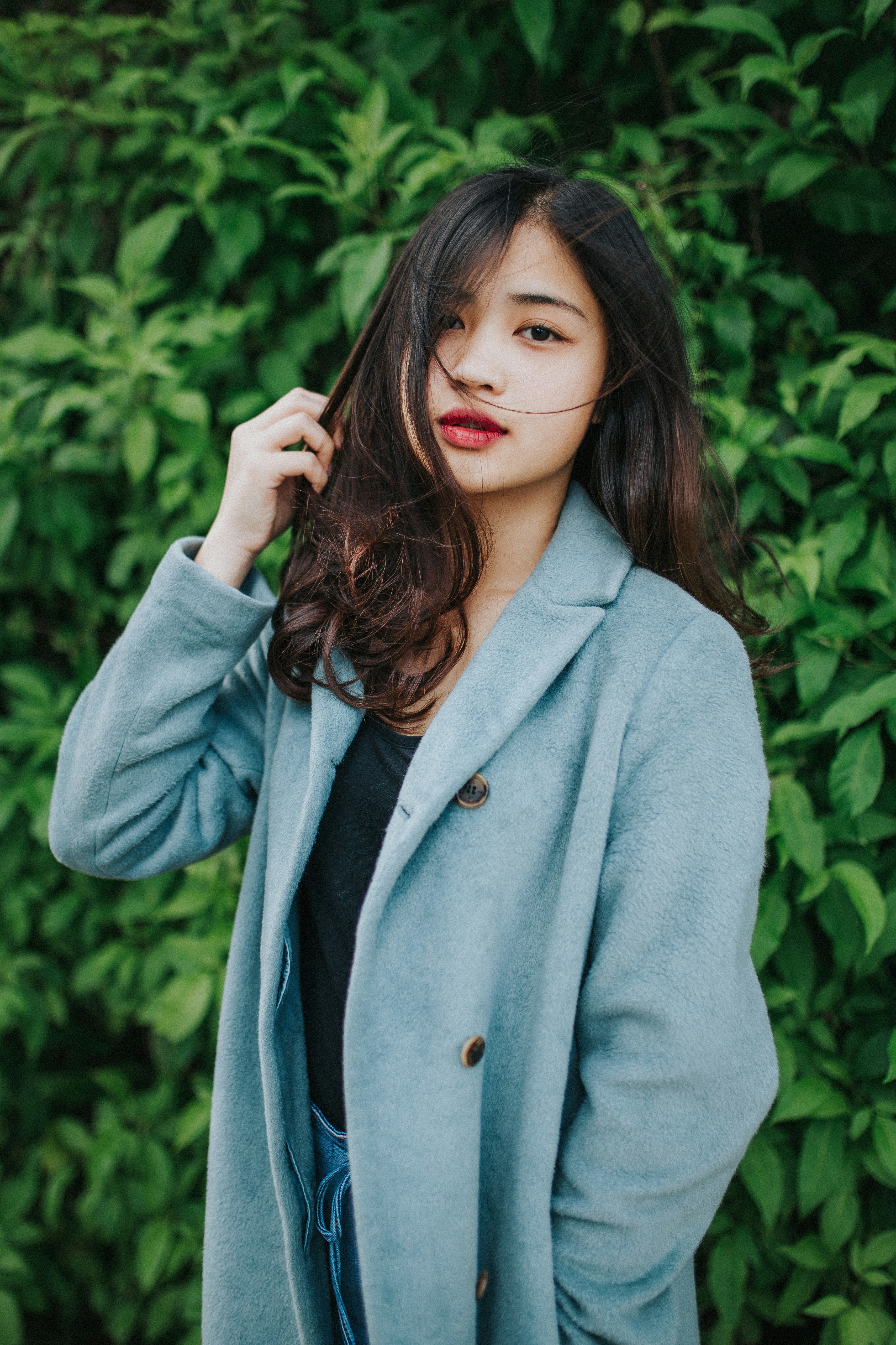 Eine Frau, die draußen steht und einen blauen Mantel trägt | Quelle: Unsplash