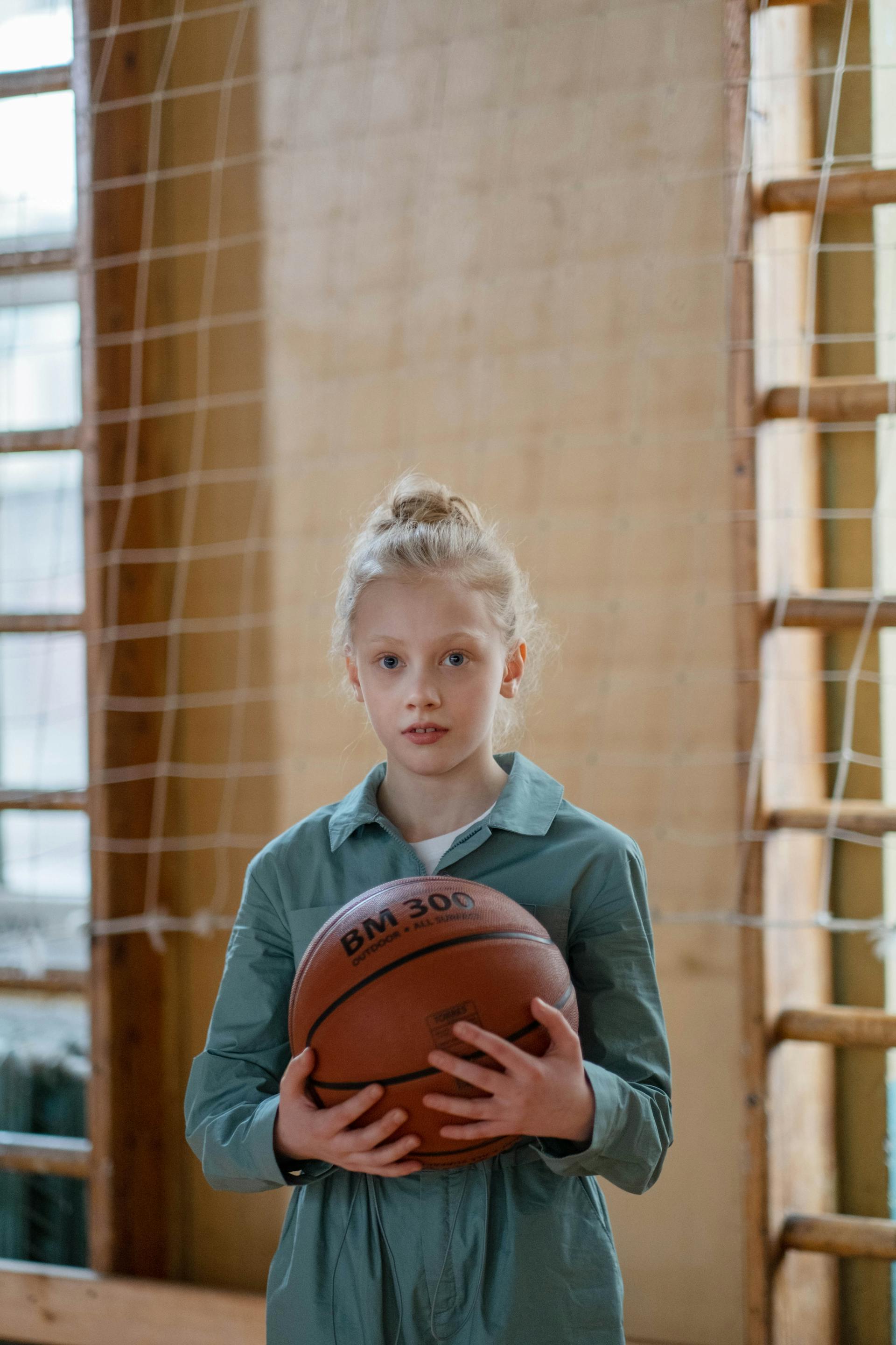 Ein nervös wirkendes Teenager-Mädchen, das einen Basketball hält | Quelle: Pexels