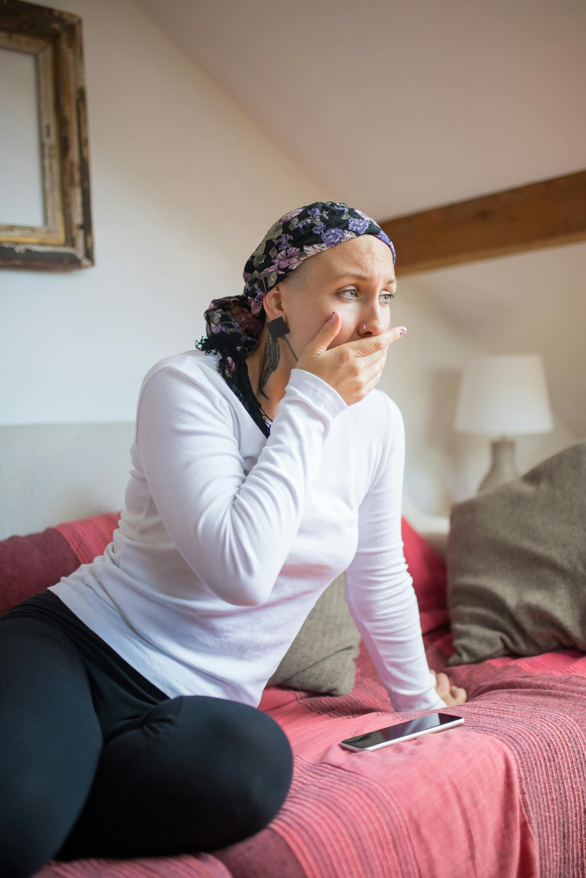 Eine Frau mit Kopftuch sitzt auf einem Sofa | Quelle: Pexels