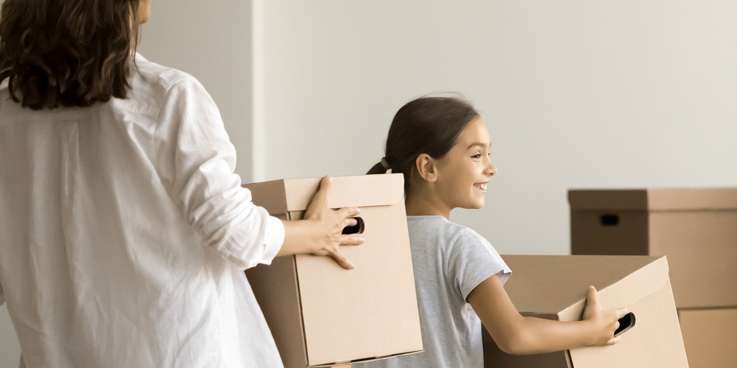 Eine Frau und ihre Tochter halten Kartons | Quelle: Shutterstock