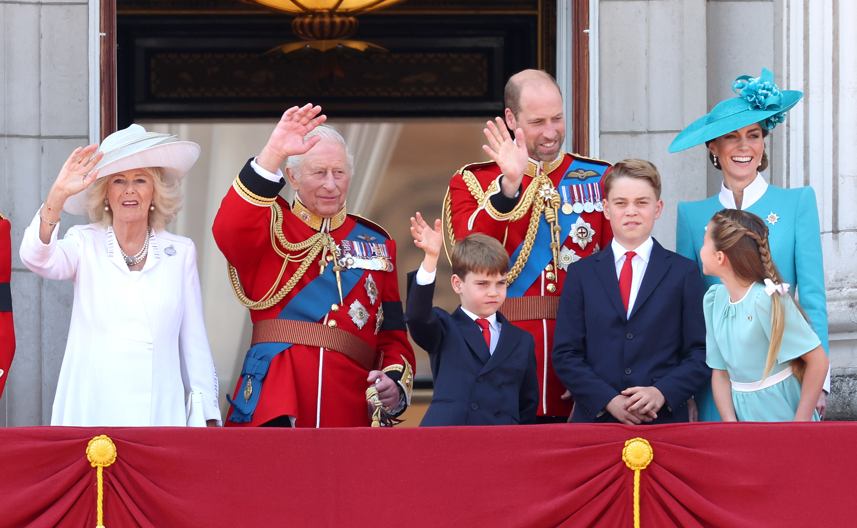 Königin Camilla, König Charles III. und der Prinz und die Prinzessin von Wales stehen während des Trooping the Colour 2025 auf dem Balkon des Buckingham Palace, zusammen mit ihren Kindern Prinz George, Prinzessin Charlotte und Prinz Louis. Auf dieser mittelgroßen Aufnahme ist Prinzessin Catherine in einem maßgeschneiderten Blazer mit weißen Manschetten und einem strukturierten weißen Kragen zu sehen. Das Ensemble, das im Detail zu sehen ist, strahlt königliche Raffinesse aus, während die königliche Familie das Militärspektakel beobachtet und den versammelten Menschenmengen zuwinkt.