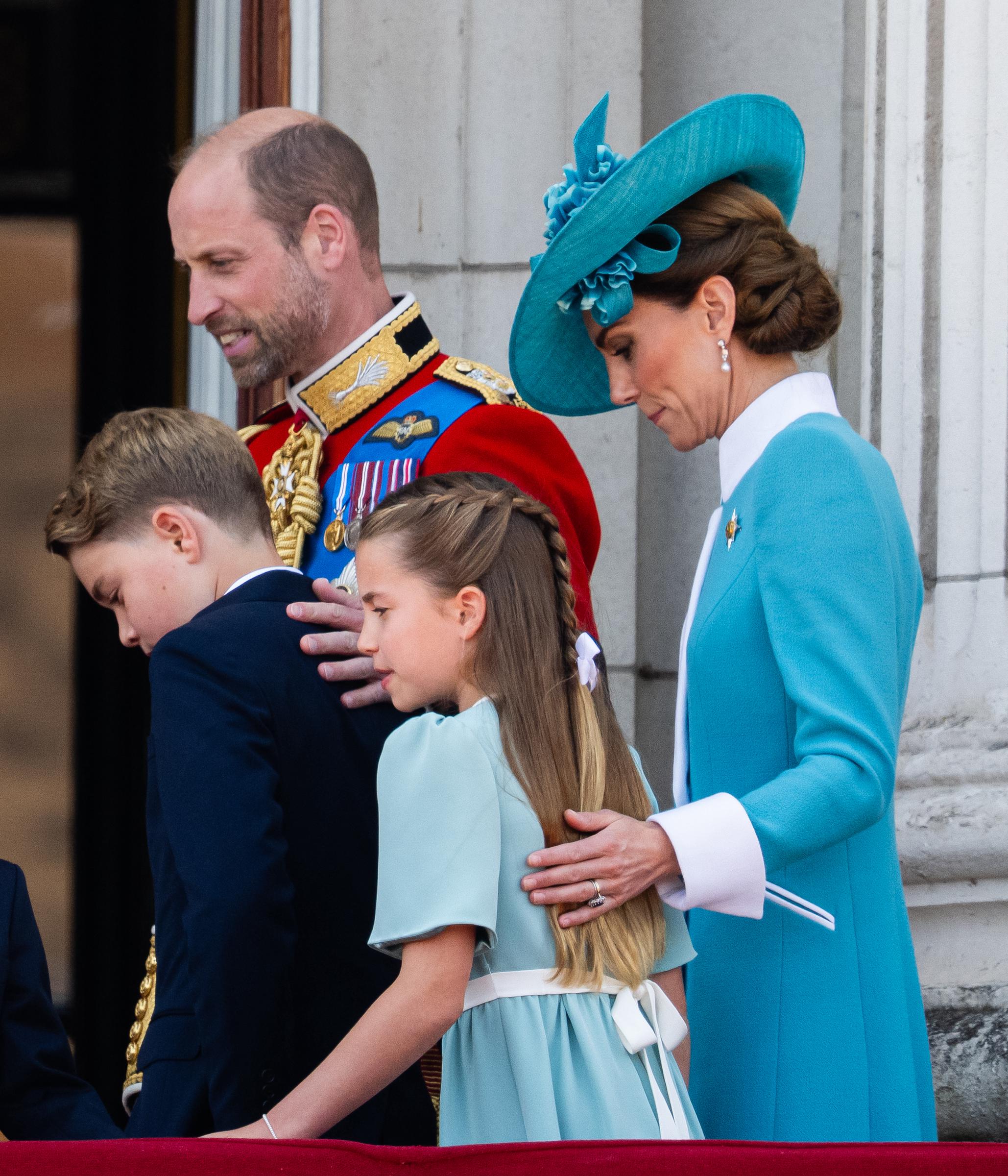 Auf einer Dreiviertelaufnahme, die während des Trooping the Colour 2025 aufgenommen wurde, stehen Prinz William und Prinzessin Catherine mit ihren Kindern - Prinz George, Prinzessin Charlotte und Prinz Louis - und zeigen eine einheitliche und anmutige Familienpräsenz. Die Familie ist in abgestimmte formelle Kleidung gekleidet und wirkt gelassen und aufmerksam, was ihre zentrale Rolle bei den feierlichen Veranstaltungen des Tages widerspiegelt.