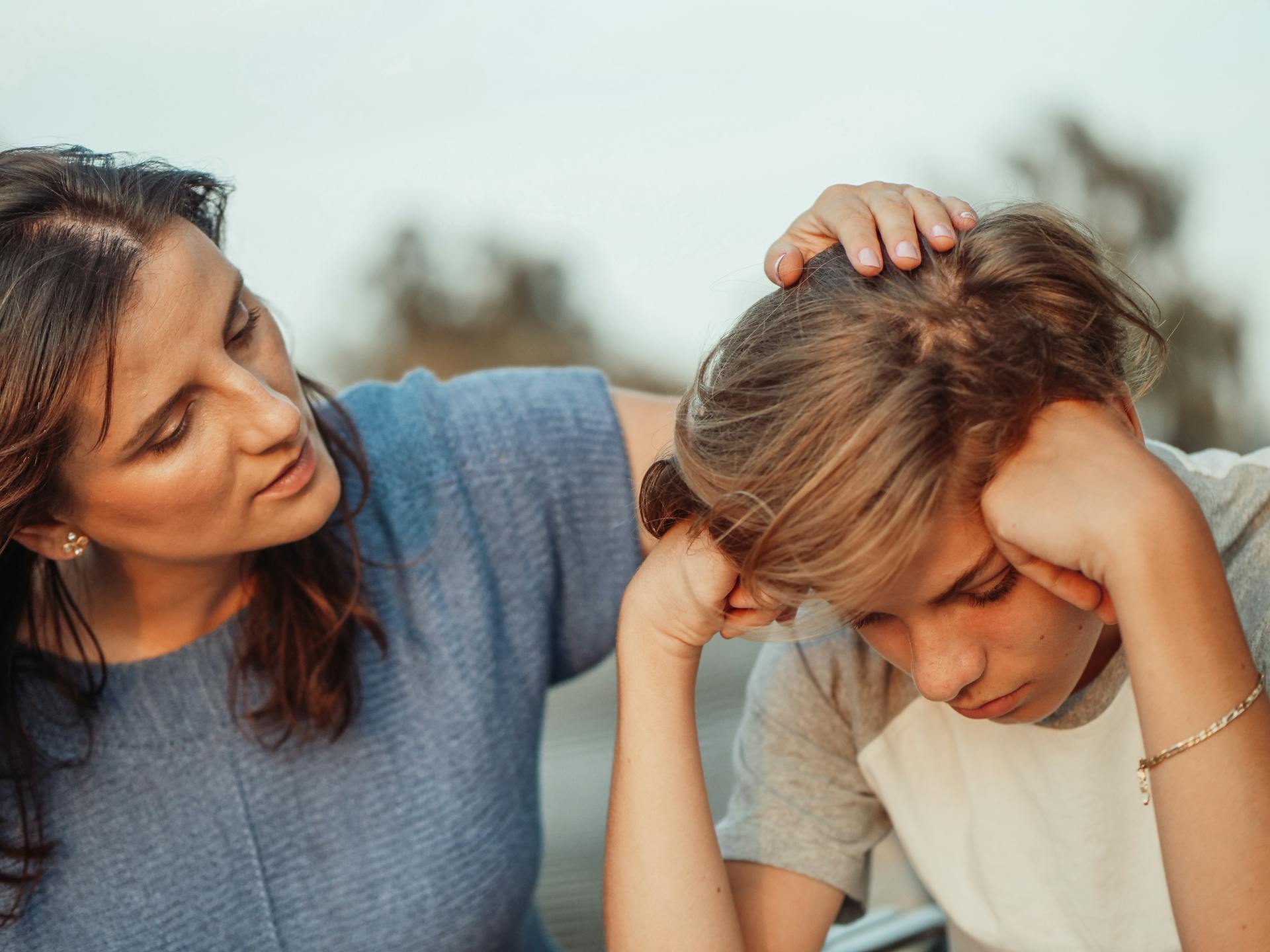Eine Frau, die ihren verzweifelten Sohn tröstet | Quelle: Pexels