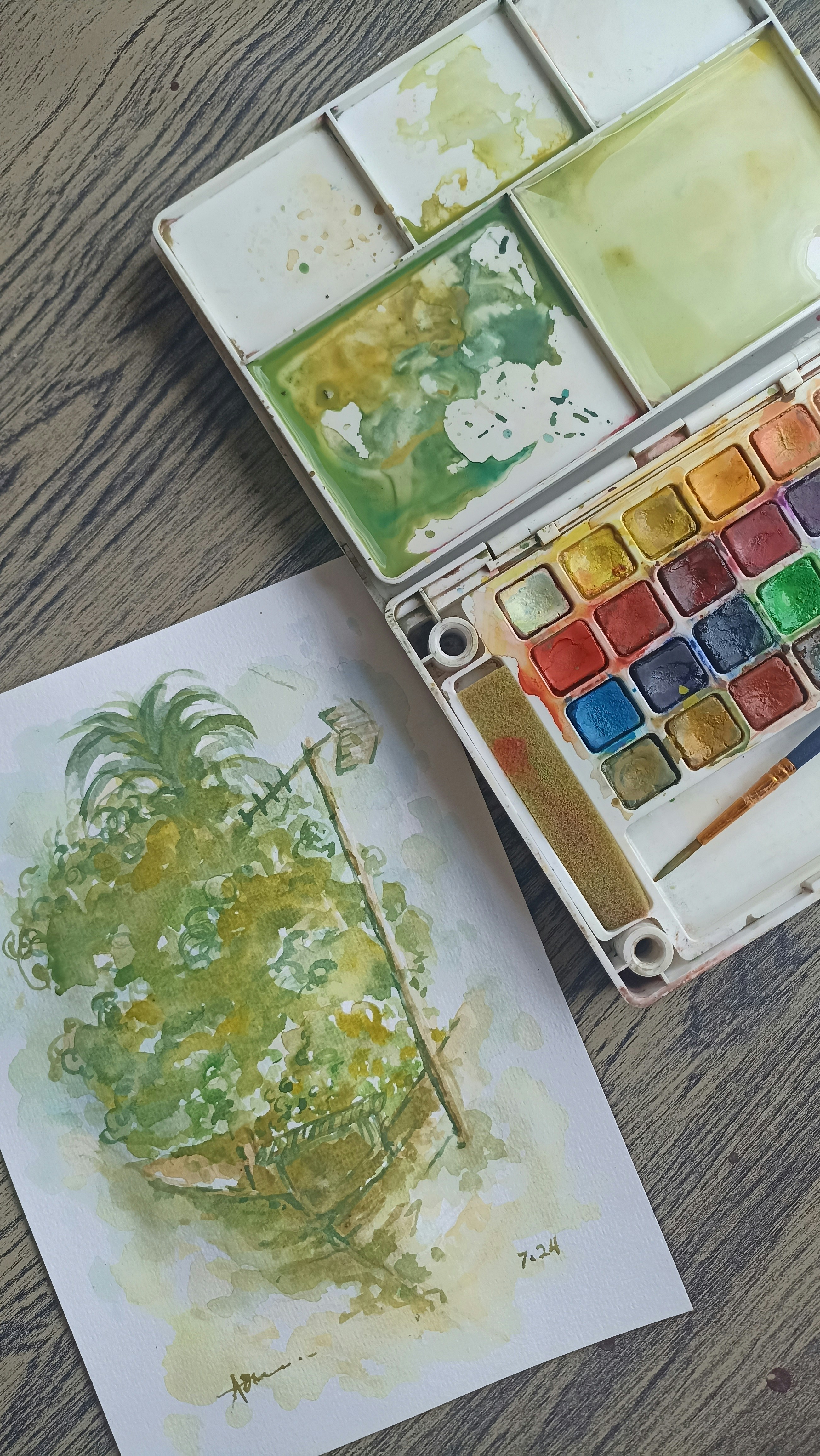 Ein Aquarell-Farbset und ein Kunstwerk | Quelle: Unsplash