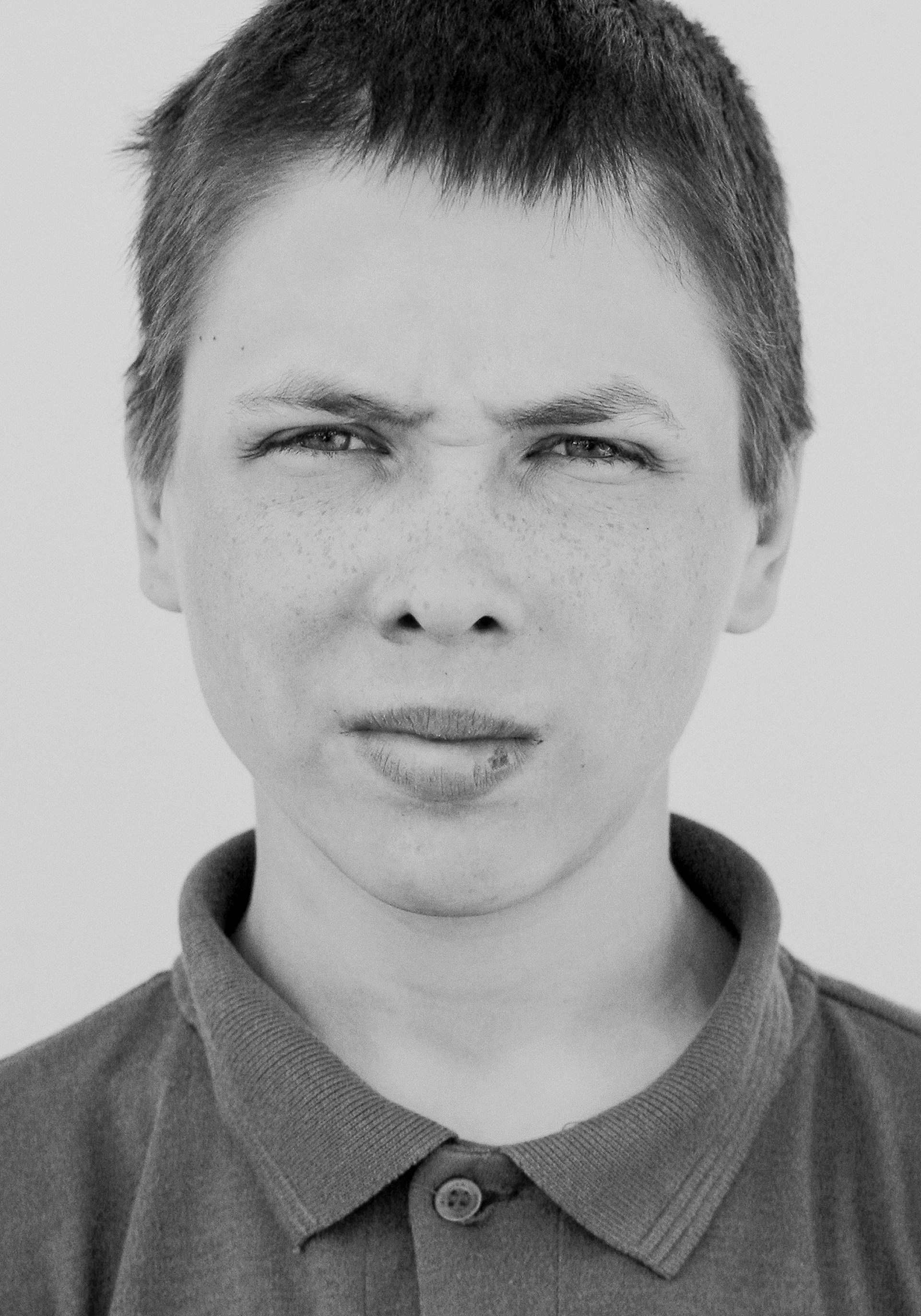 Ein Junge, der jemandem eine Grimasse schneidet | Quelle: Unsplash
