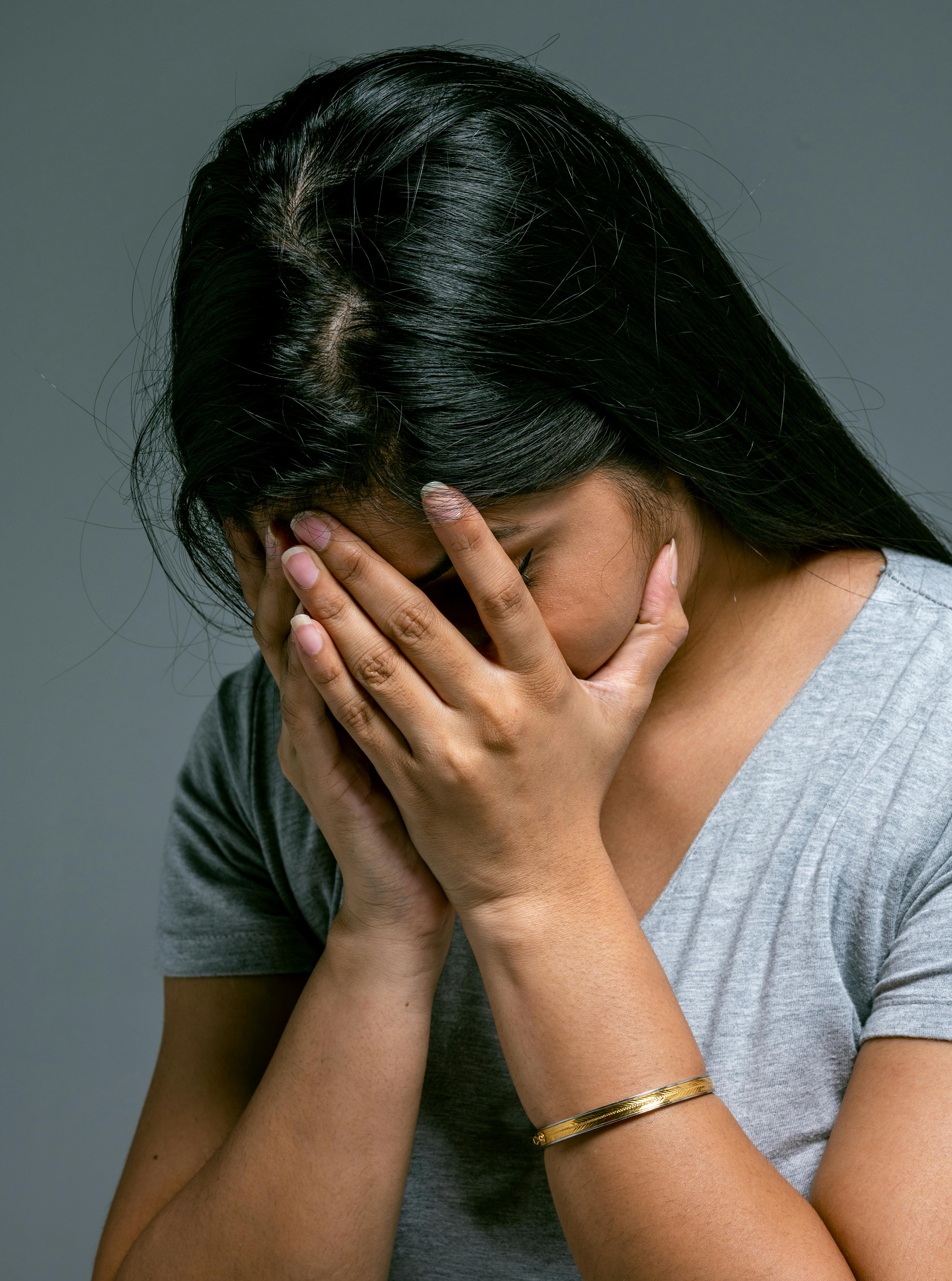 Frau versteckt ihr Gesicht | Quelle: Pexels