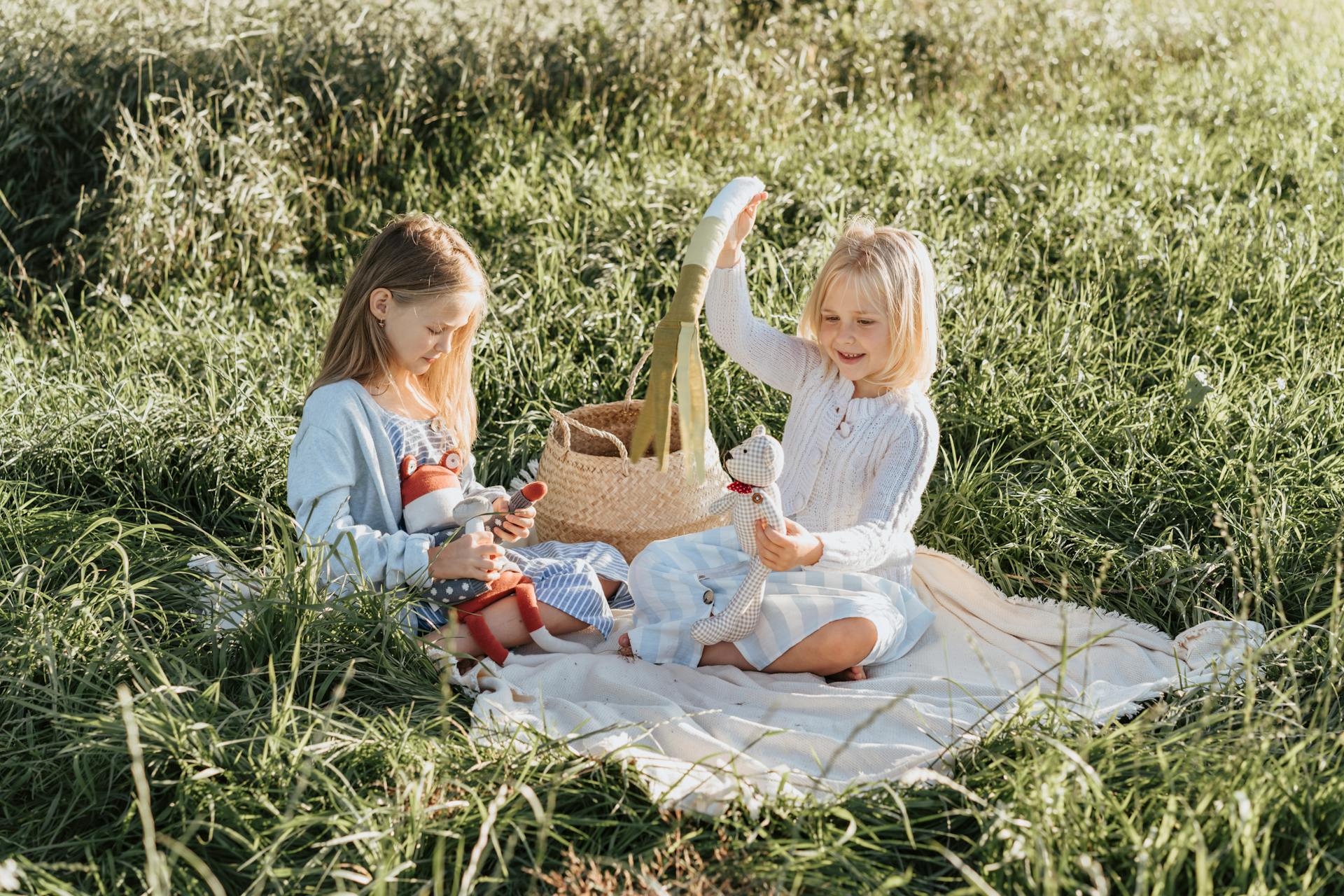 Zwei kleine Mädchen sitzen in einem Park | Quelle: Pexels