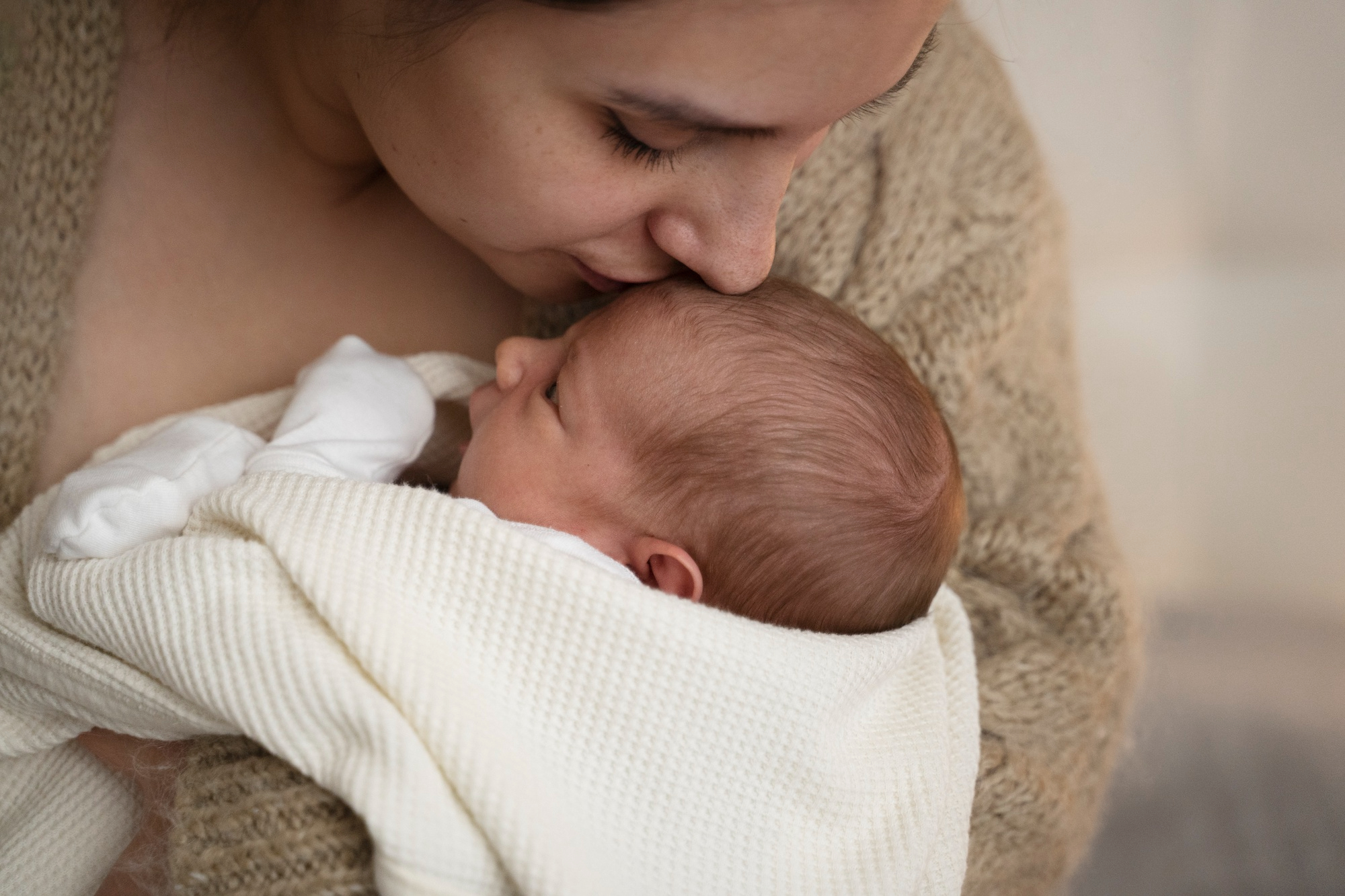 Eine Frau, die ihr Baby küsst | Quelle: Freepik
