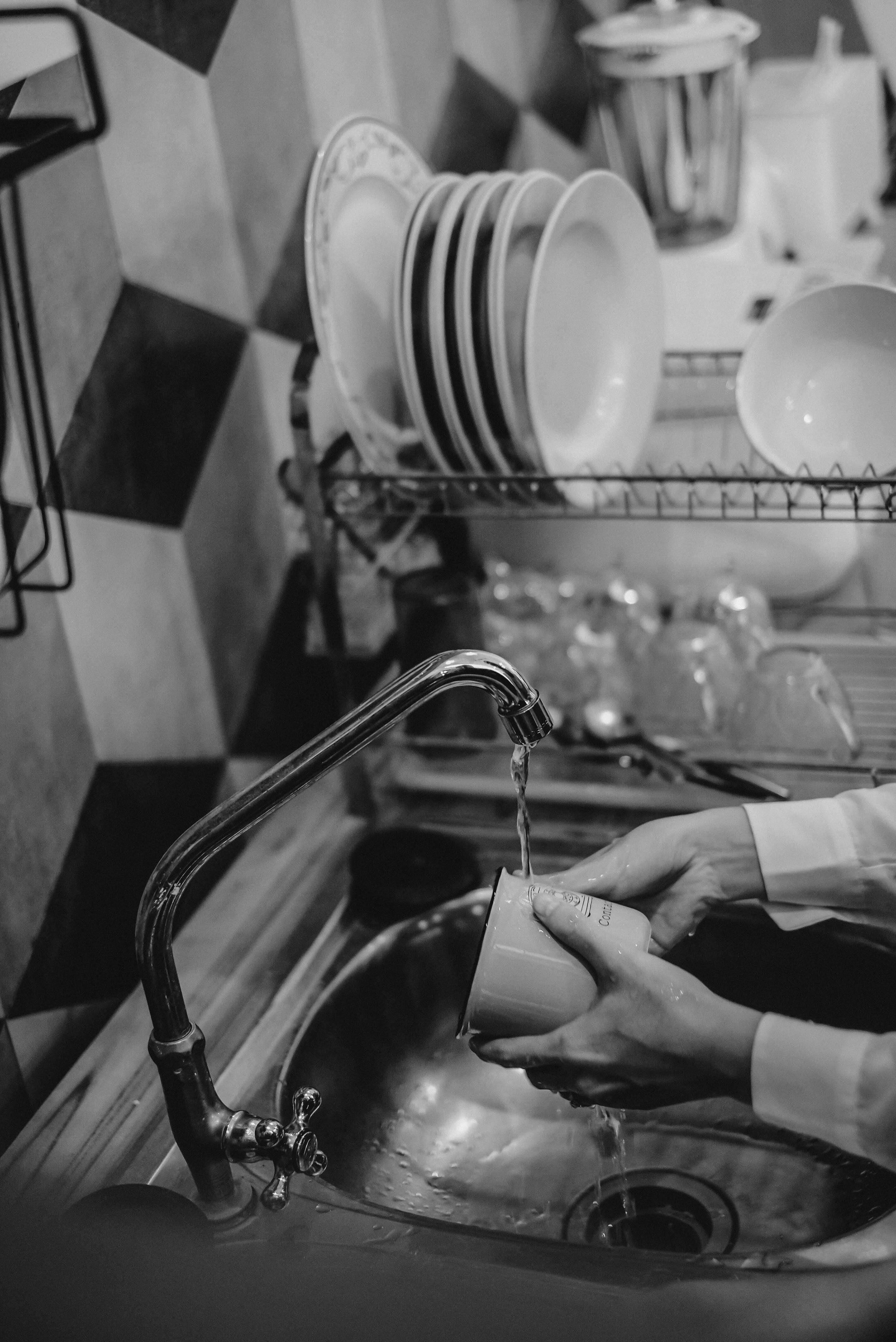 Eine Person wäscht einen Becher | Quelle: Pexels
