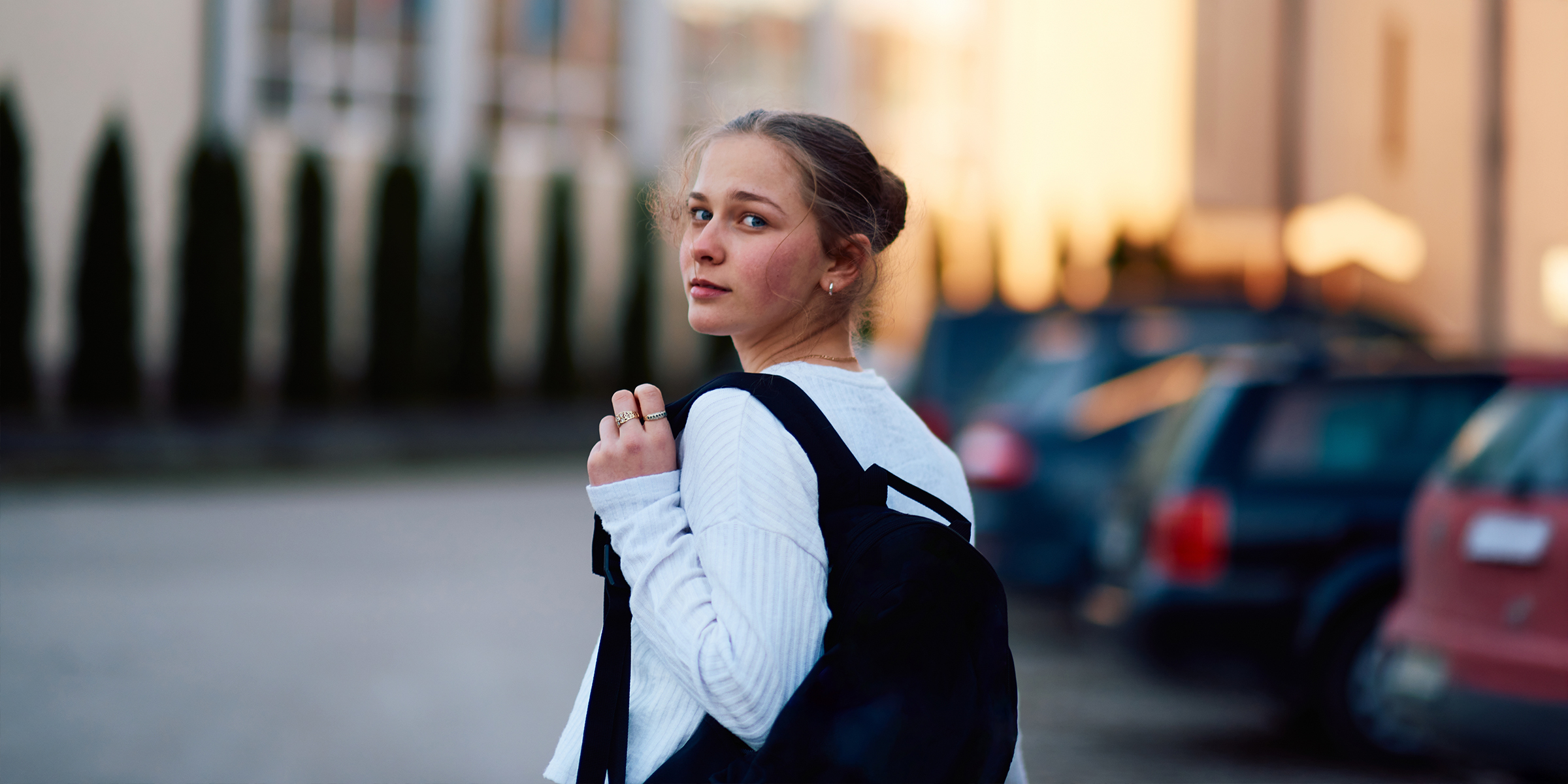 Ein Teenager-Mädchen, das über seine Schulter schaut | Quelle: Shutterstock