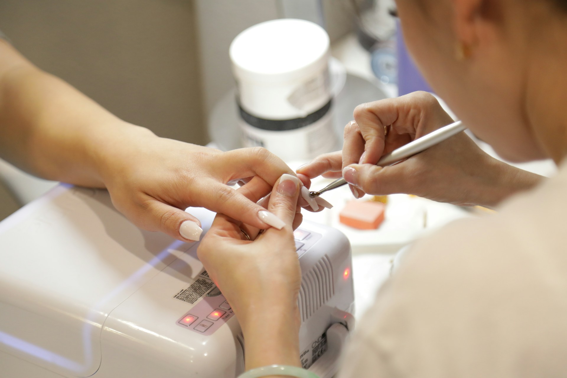 Eine Kundin, die sich in einem Nagelstudio die Nägel machen lässt | Quelle: Unsplash