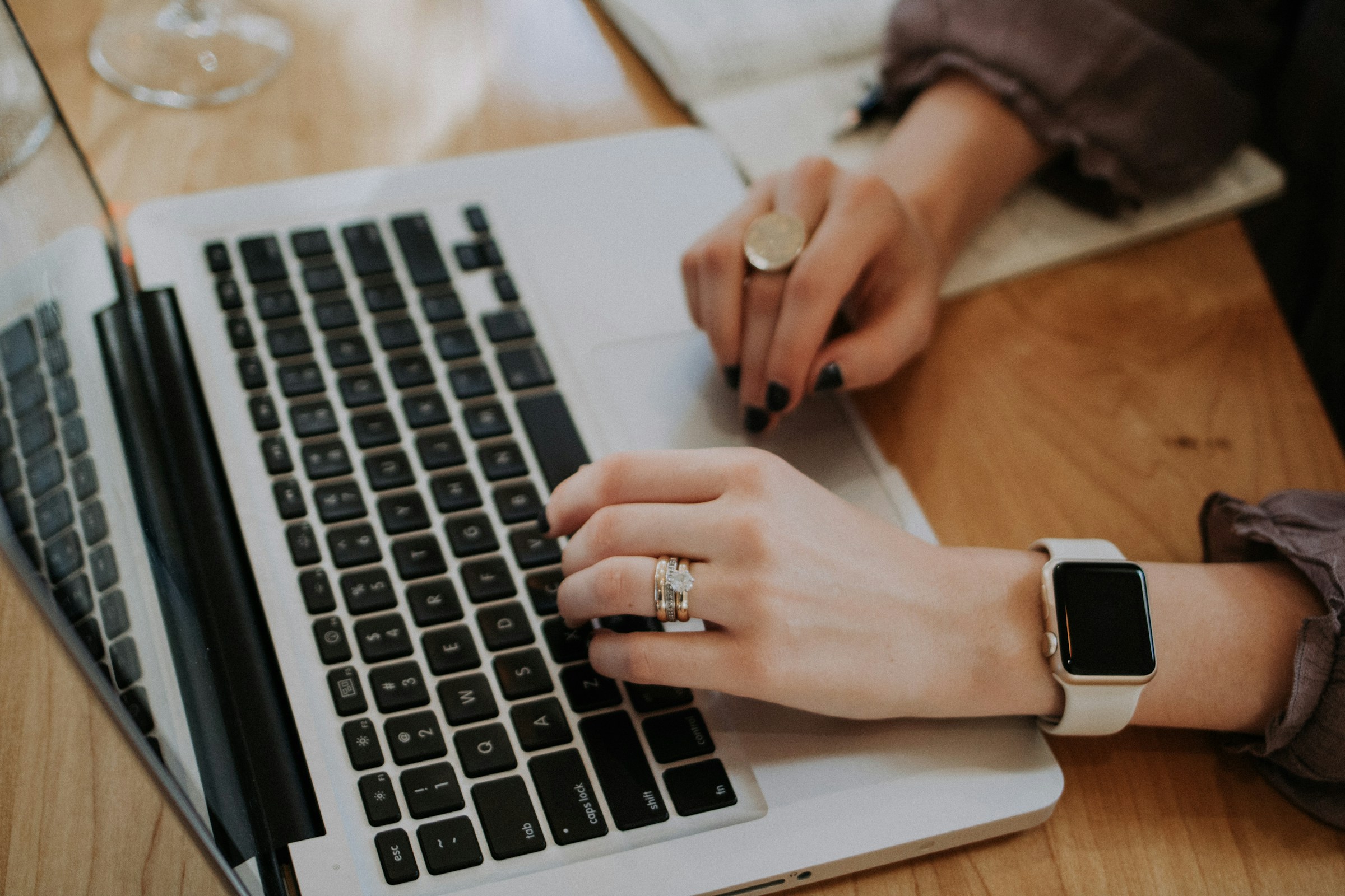 Eine Nahaufnahme einer Frau, die an ihrem Laptop arbeitet | Quelle: Unsplash