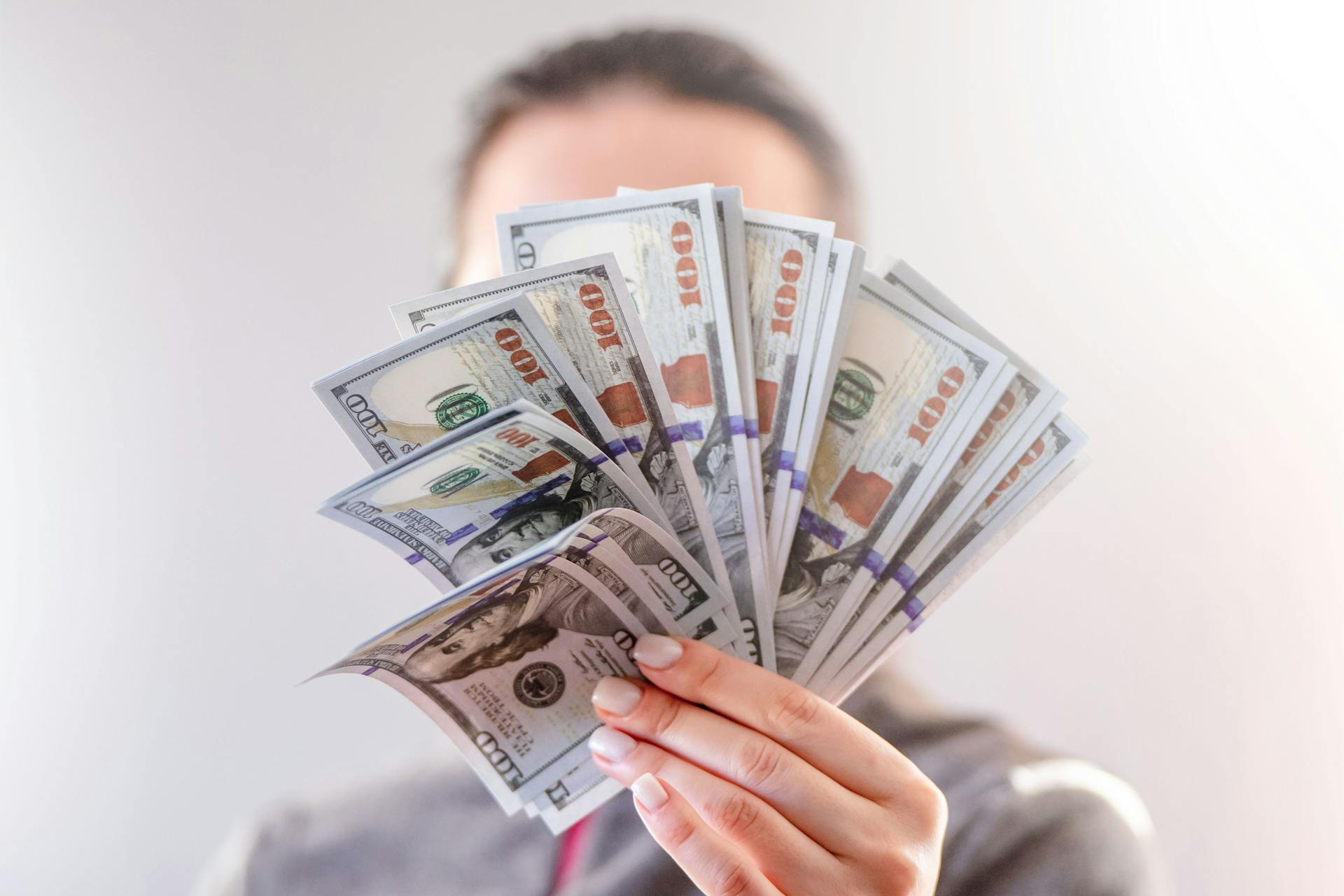 Eine Frau mit Dollarscheinen in der Hand | Quelle: Pexels