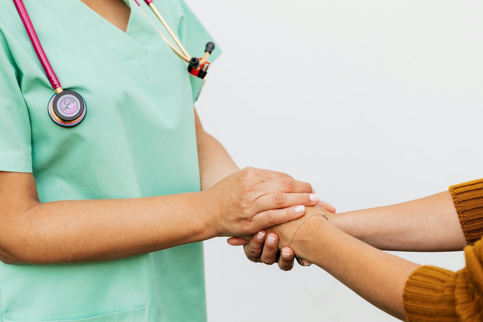 Eine Krankenschwester hält die Hände eines Patienten | Quelle: Pexels