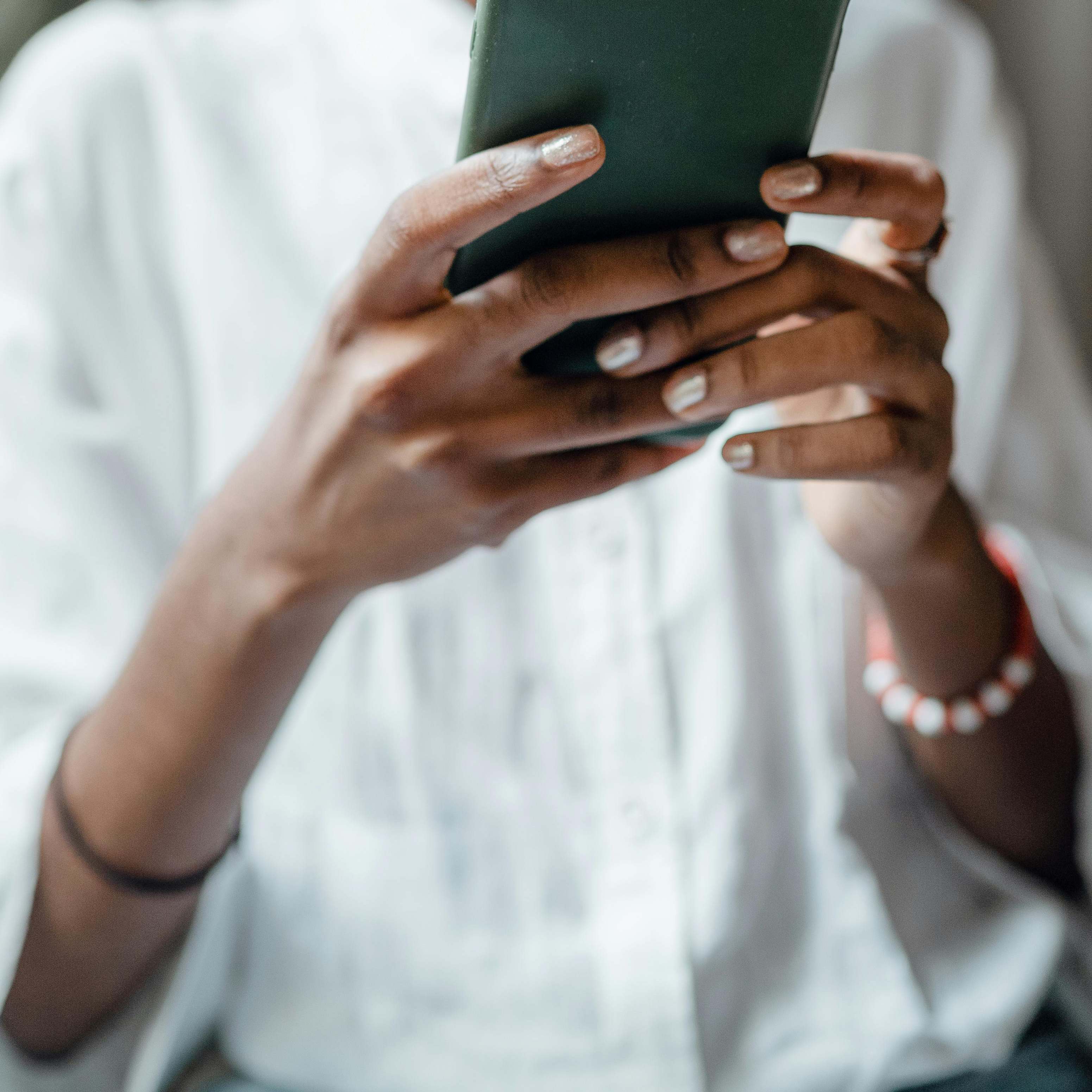 Eine Frau hebt ein Mobiltelefon auf | Quelle: Pexels