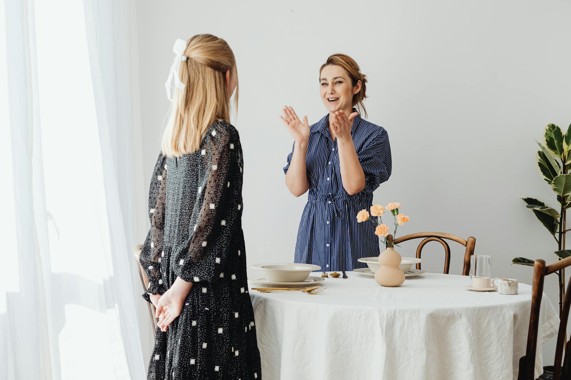 Eine lächelnde Frau, die ihrer Teenager-Tochter eine Geschichte erzählt | Quelle: Pexels