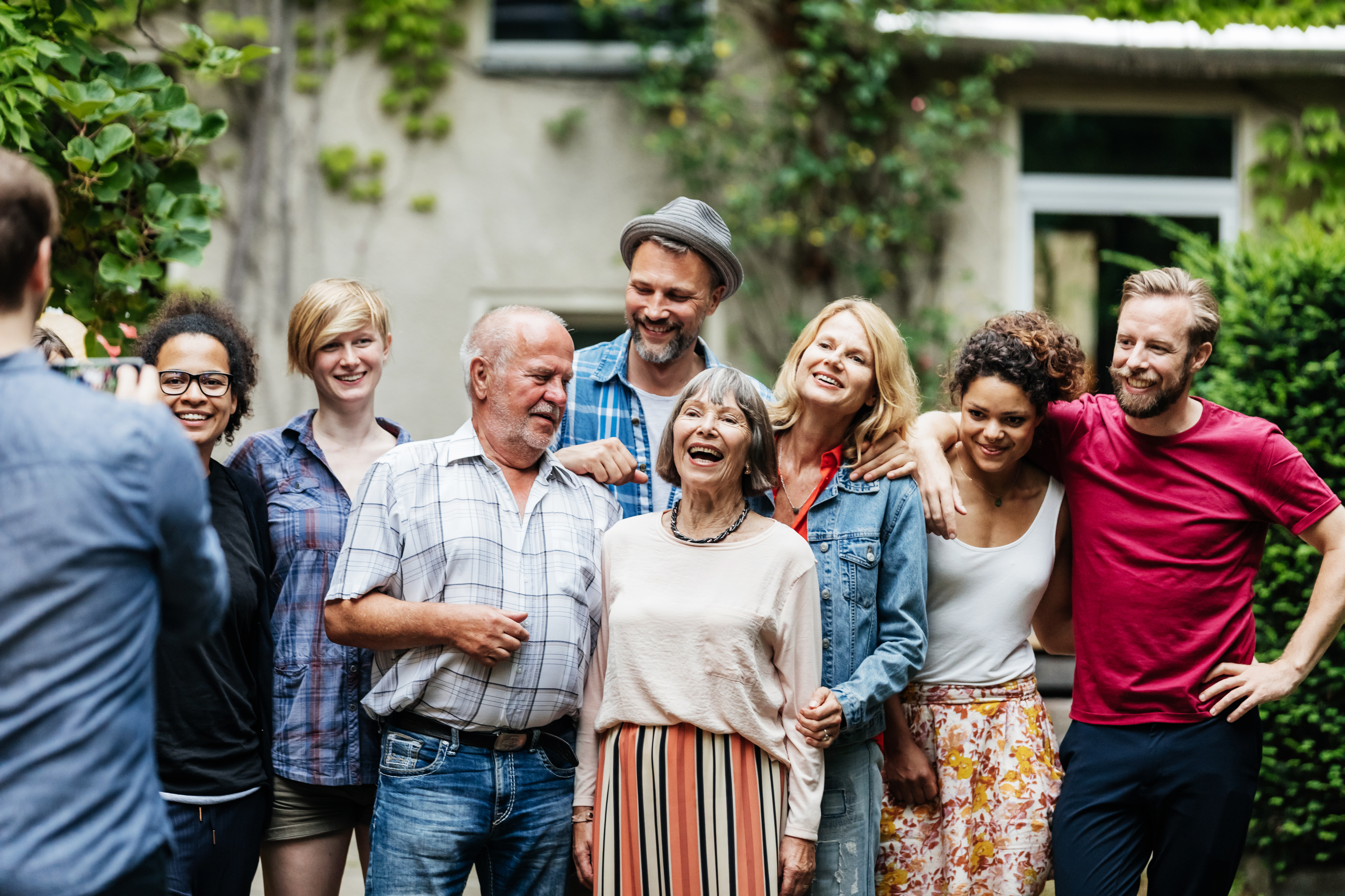 Ein Mann macht ein Gruppenfoto mit seiner Familie beim Grillen | Quelle: Getty Images