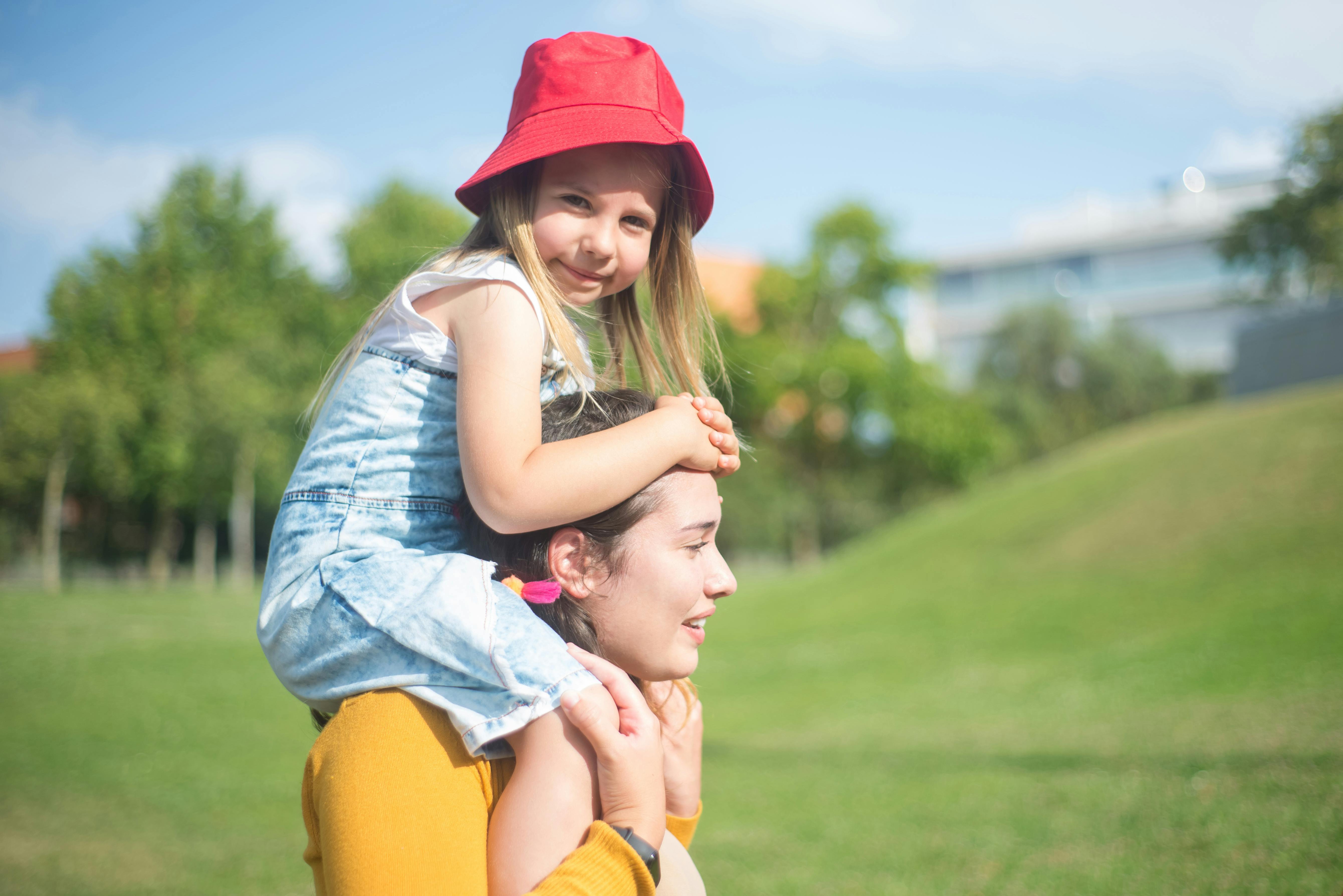 Eine Frau trägt ein Kind auf ihren Schultern | Quelle: Pexels