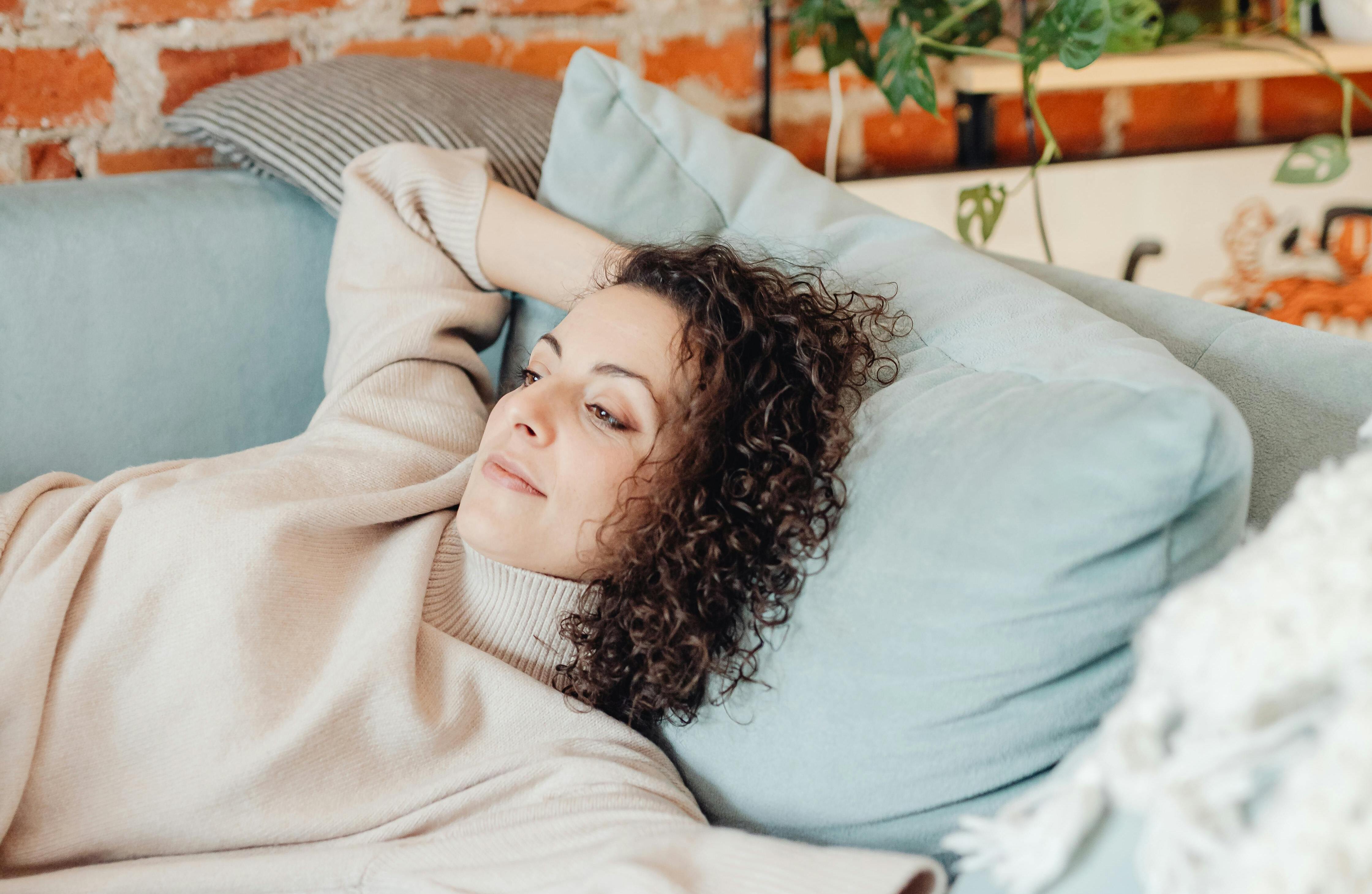 Eine Frau, die auf einer Couch liegt | Quelle: Pexels
