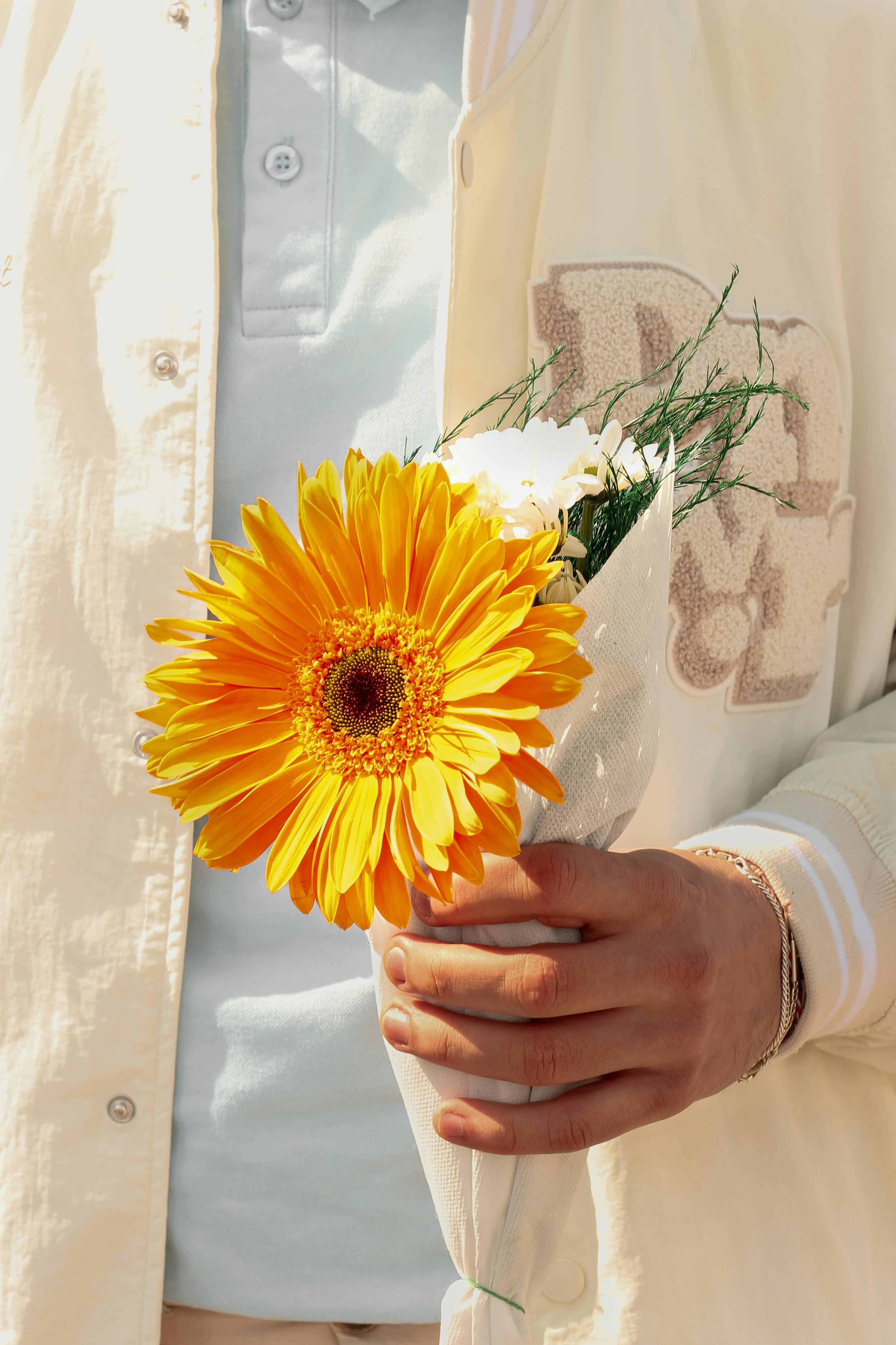 Ein Mann hält Blumen | Quelle: Pexels