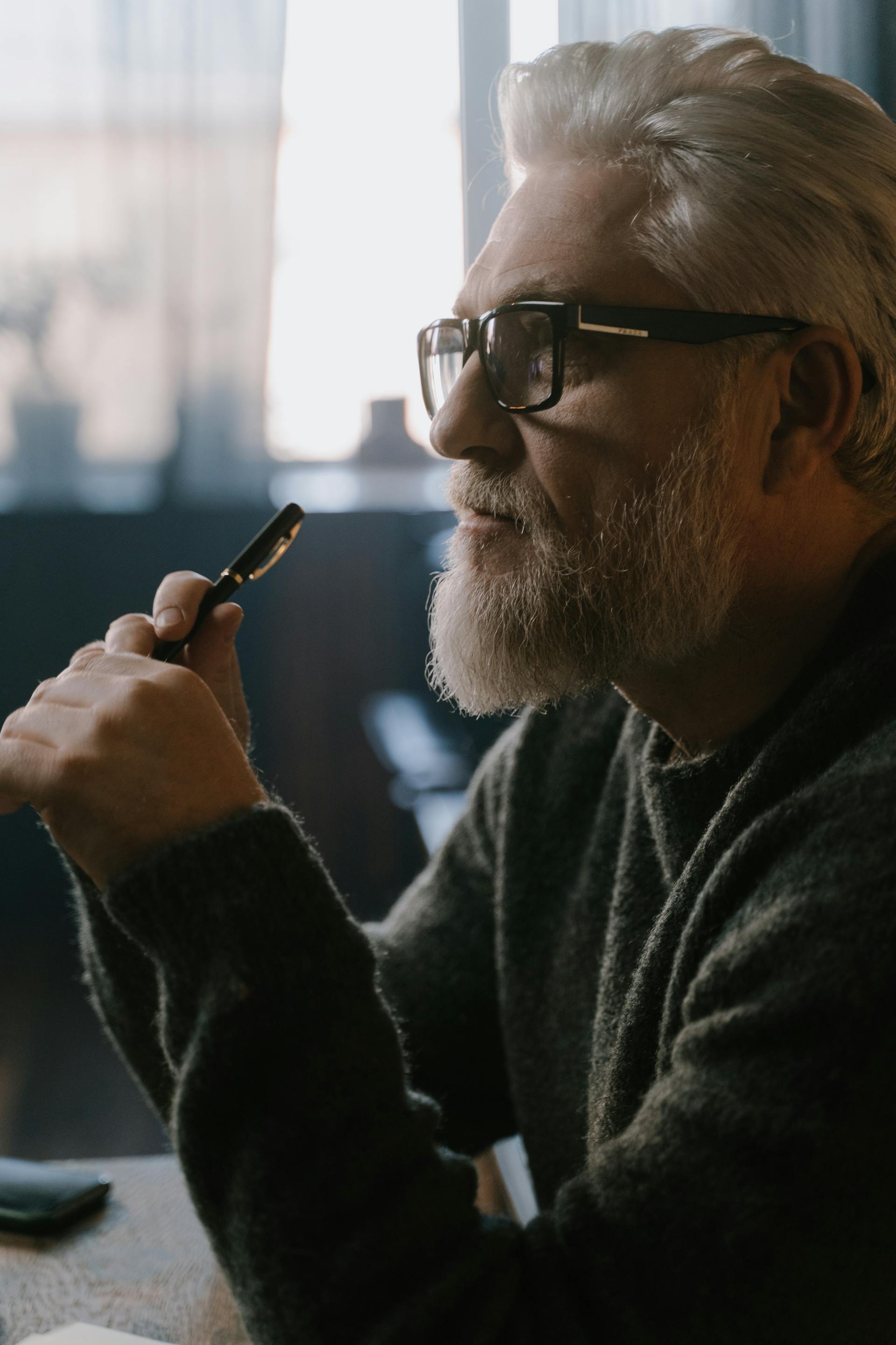 Ein nachdenklicher Mann hält einen Stift | Quelle: Pexels