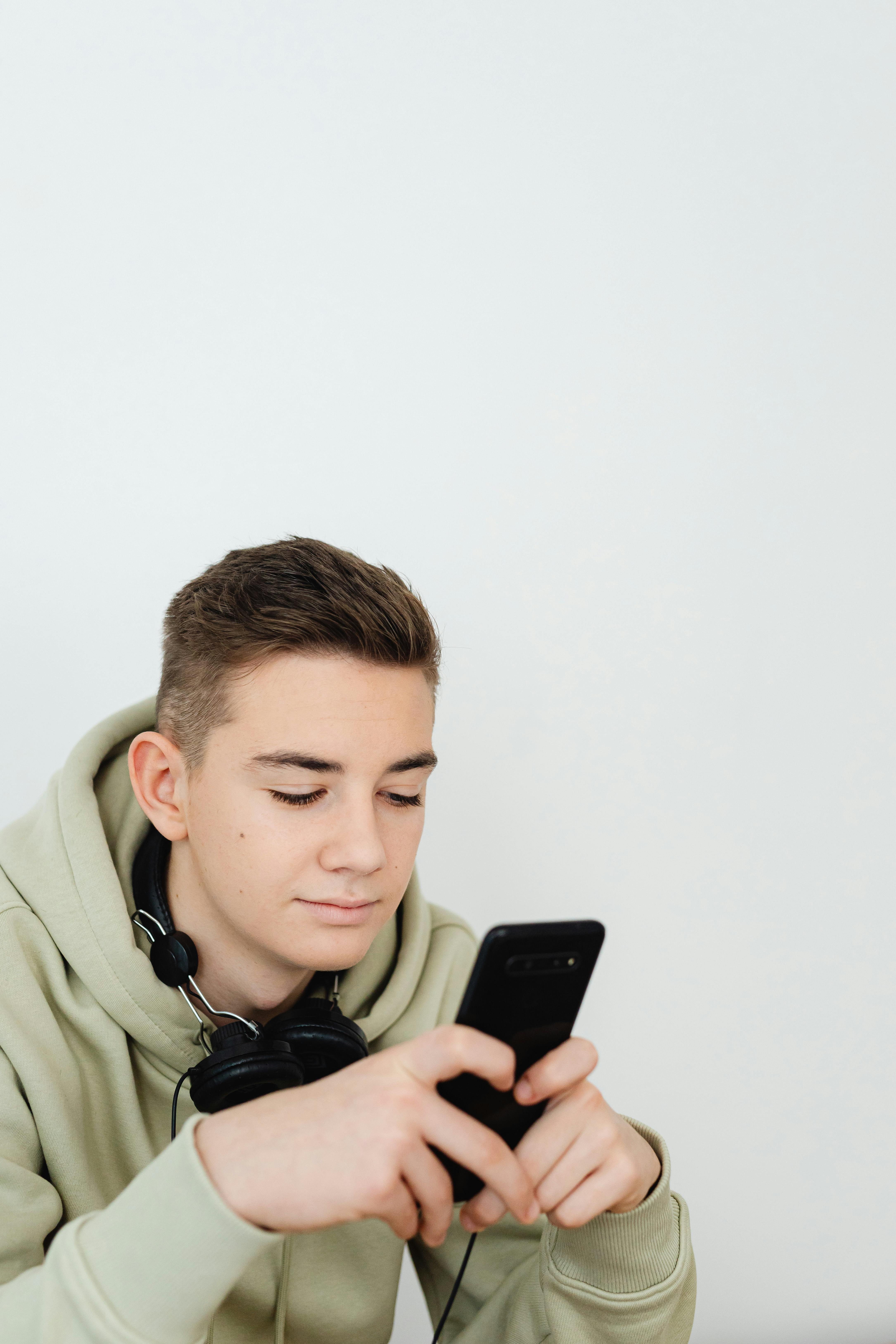 Ein Jugendlicher, der ein Telefon benutzt | Quelle: Pexels
