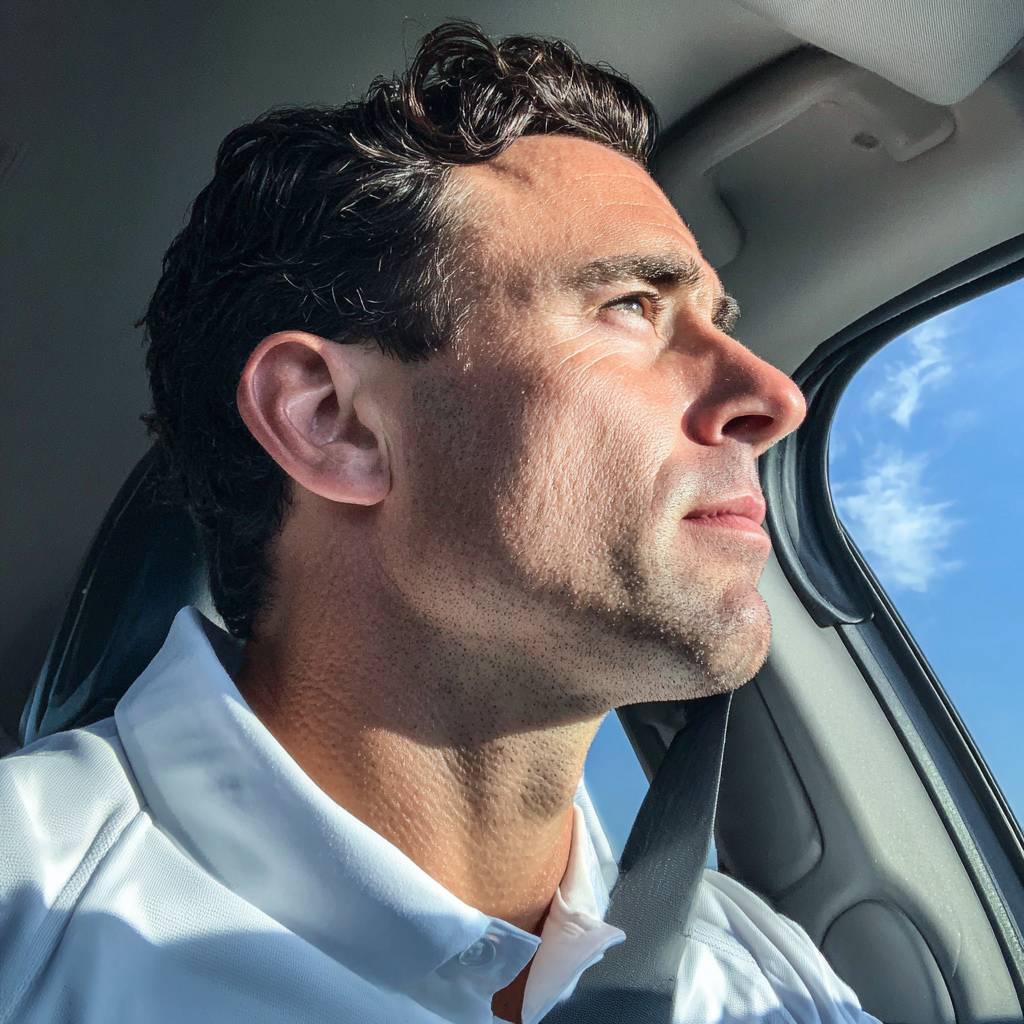 Ein Mann am Steuer eines Autos | Quelle: Midjourney